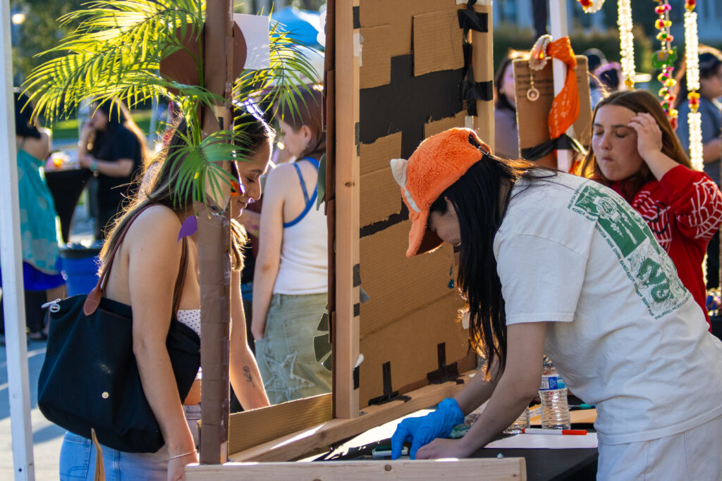 A volunteer takes a student order at the Indonesia booth for the March 14 Asian Student Association Night Market.