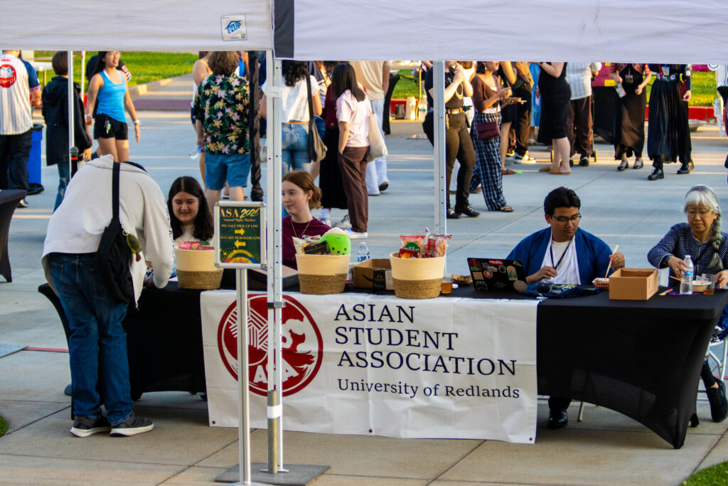 The University of Redlands' Asian Student Association Cabinet members and volunteers welcome people to the March 14 ASA Night Market at the ticket counter. 